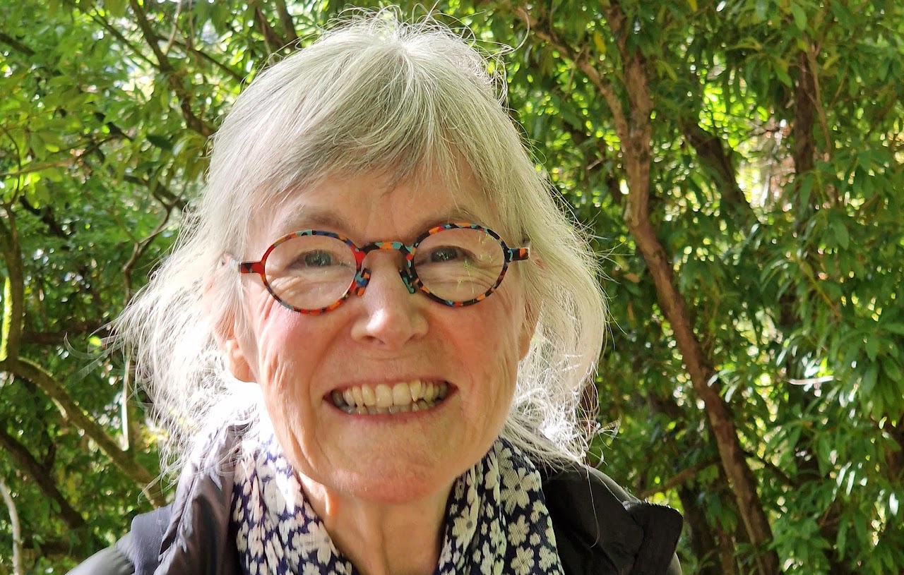 Gill Brophy smiling in a garden