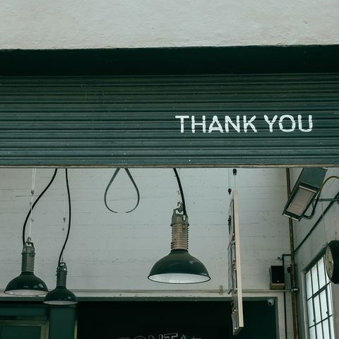 Green café shopfront with a Thank You sign (mood photo)