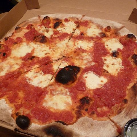 A margherita pizza with fresh basil (mood photo)